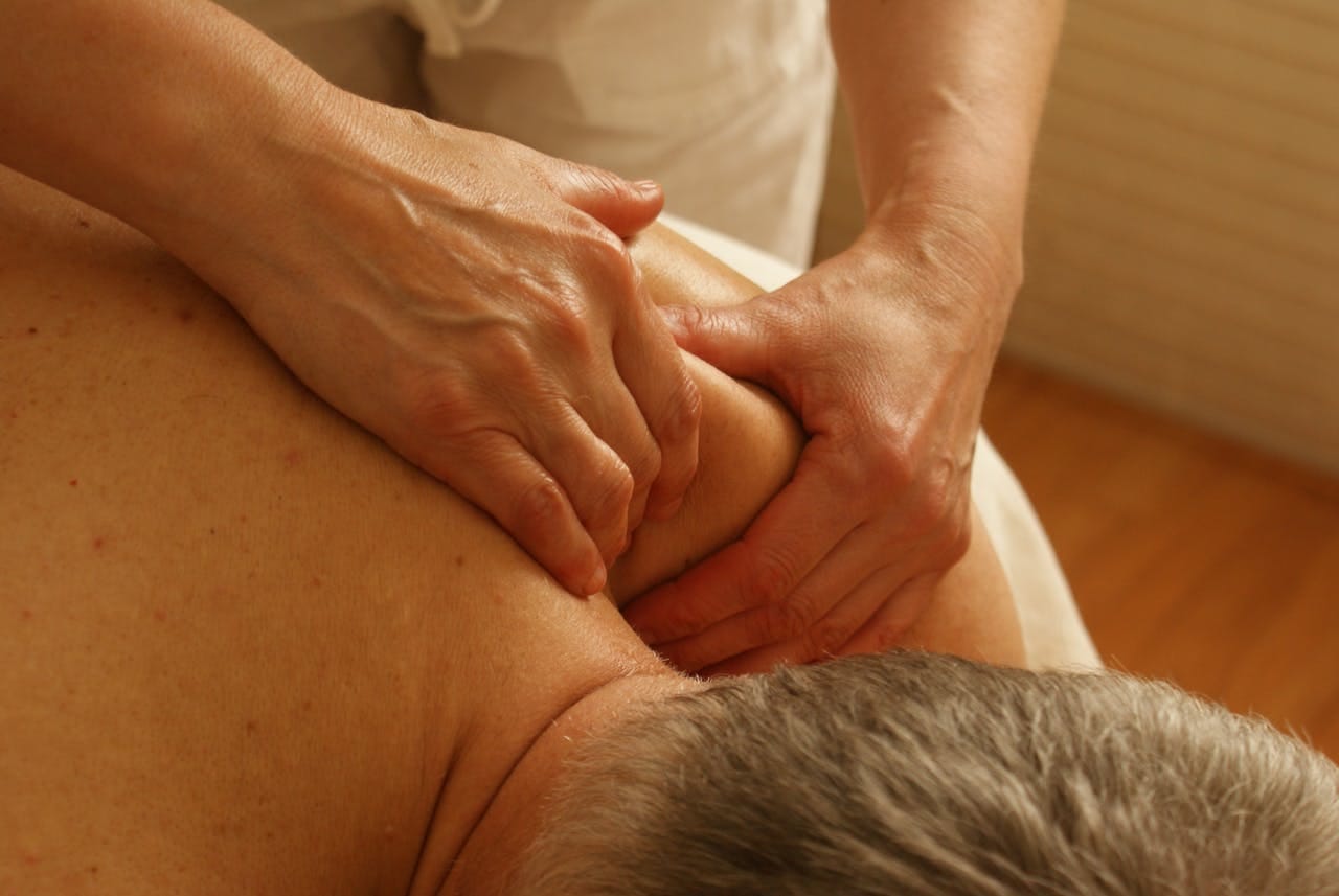 about-us-02 Close-up of a therapist giving a relaxing shoulder massage, enhancing wellness and stress relief.